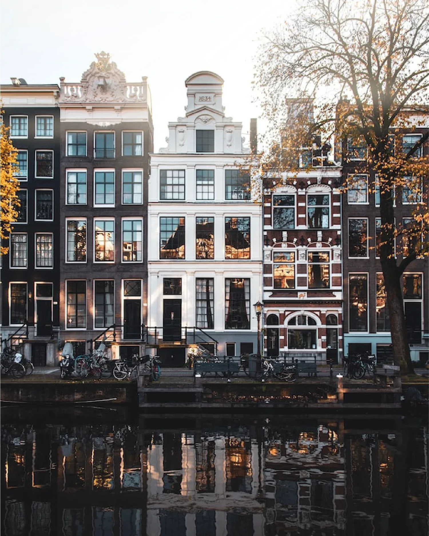Klassieke Amsterdamse grachtenpanden weerspiegeld in het water, Nieuw Amsterdams Huys